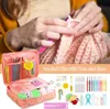 A person is crocheting with a pink crochet hook, and a pink crochet kit with various accessories is displayed below. Produktbild-Vorschau