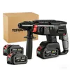 A cordless hammer drill with two extra batteries and a cardboard box. Podgląd zdjęcia produktu