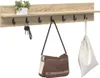 A wall-mounted coat rack with a shelf, hooks, and items hanging from it. Náhled obrázku produktu