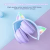A pair of purple cat-ear headphones with LED lights, folded and placed on a pastel blue and purple background. Podgląd zdjęcia produktu