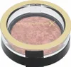 A close-up, top-down view of a round makeup compact with a clear lid and gold trim. Anteprima dell’immagine prodotto