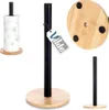 A collage of images showing a paper towel holder with a black metal stand and a wooden base. One image shows the holder with paper towels, another shows a close-up of the base, and a third shows the holder without paper towels. Náhled obrázku produktu