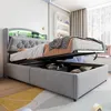 A modern bedroom with a grey upholstered bed frame, featuring a lifted mattress to reveal storage space underneath. The headboard has integrated LED lighting. Náhled obrázku produktu