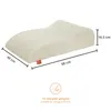 A cream-colored orthopedic pillow with dimensions indicated by measurement lines and text. Produktbild-Vorschau