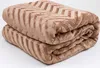A folded brown blanket with a chevron pattern. Podgląd zdjęcia produktu