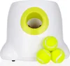 A white automatic ball launcher for dogs with three tennis balls in front of it. Náhled obrázku produktu