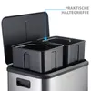 Close-up view of the interior of a stainless steel trash can with two black compartments, showing the removable inner bins and the open lid. Podgląd zdjęcia produktu