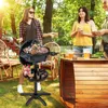 Three people are gathered in a backyard setting, enjoying a barbecue with an electric grill. Náhled obrázku produktu