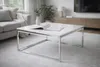 A modern living room with a couch, coffee table, and TV stand. Produktbild-Vorschau