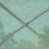 Close-up view of the internal structure of a greenhouse, showing the metal frame covered by a green mesh-like plastic sheeting. Produktbild-Vorschau