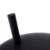 A close-up view of a black metal object, possibly a grill or fire pit, with a black handle protruding from its surface. Produktbild-Vorschau