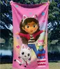 A pink towel with cartoon characters is held up outdoors. Náhled obrázku produktu