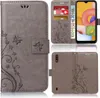 A collage of images showing a grey flip phone case with a floral pattern, a phone inserted into the case, and the case from the back. Produktbild-Vorschau