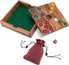 A wooden board game with colorful playing pieces, a dice, and a drawstring bag. Produktbild-Vorschau