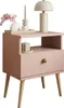 A pink nightstand with decorative items on top and in the open shelf. Náhled obrázku produktu