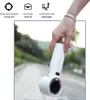A hand holding a white portable fan outdoors. Náhled obrázku produktu