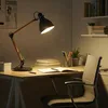 A desk with a lamp, books, and a chair, suggesting a study or work area. Náhľad obrázku produktu