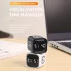 Two cube timers are stacked on a desk next to a laptop. Produktbild-Vorschau