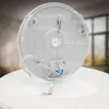 The underside of a white ceiling lamp with labels pointing to different parts. Náhľad obrázku produktu