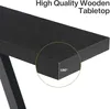 Close-up of the edge of a black wooden tabletop, highlighting its thickness. Produktbild-Vorschau