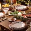 A festive Christmas table setting with plates, food, and decorations. Náhľad obrázku produktu