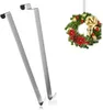Two silver door hooks and a Christmas wreath. Produktbild-Vorschau