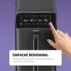 A hand is shown interacting with the digital display of a black air fryer. Produktbild-Vorschau