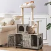A cat tree with multiple levels and enclosed spaces, featuring two cats interacting with it. A sofa is visible in the background. Podgląd zdjęcia produktu