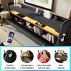A bed with a headboard featuring storage, USB ports, and LED lighting, shown with a smartphone controlling the lights. Produktbild-Vorschau