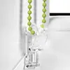A close-up of a clear plastic bead chain holder for a window blind. Produktbild-Vorschau