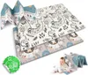 A baby is crawling on a folded play mat with cartoon animals and a game board design. The mat is folded in half and then in half again, creating a zig-zag shape. Another folded mat is visible behind it. Voir les images du produit