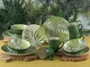 A collection of tableware with a tropical leaf pattern, set against a jungle-themed backdrop. Náhľad obrázku produktu