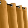 A close-up view of several mustard yellow curtains hanging on a black rod. Náhled obrázku produktu