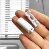 A hand holding two white plastic parts for blinds. Produktbild-Vorschau