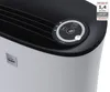Close-up of the top section of a white and black air purifier, showing the control panel and air vents. Podgląd zdjęcia produktu