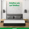 A bedroom scene with a bed and mattress, featuring a motivational quote on the wall. Produktbild-Vorschau