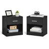 Two black nightstands with items on and inside them, isolated on a white background. Náhled obrázku produktu