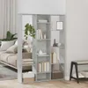 A modern living room with a concrete-gray bookshelf acting as a room divider, filled with books and decorative items. A sofa is visible in the background. Náhľad obrázku produktu
