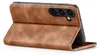 A brown leather flip case for a smartphone is shown from a side-angle, with the phone partially inserted and the front cover folded open. Produktbild-Vorschau