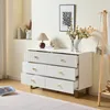 A modern white dresser with gold accents, decorated with a lamp, flowers, and a framed picture. Anteprima dell’immagine prodotto