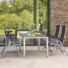 An outdoor patio setting with a table and chairs. Produktbild-Vorschau