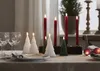 A table setting with Christmas-themed candles and glassware. Produktbild-Vorschau