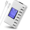 A white multi-port USB charger with a display screen and two power cables. Produktbild-Vorschau