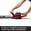 A person's hands are holding a red and black hedge trimmer against a white background. Produktbild-Vorschau