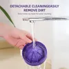 A hand holding a purple juicer attachment under a running faucet. Podgląd zdjęcia produktu