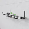 Skis mounted on a wall rack against a concrete wall. Anteprima dell’immagine prodotto