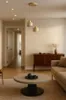 A modern living room with a coffee table, sofa, and a credenza. Produktbild-Vorschau
