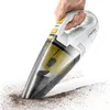 A hand holding a white and yellow TROTEC hand vacuum cleaner, which is cleaning up dirt from a white surface. Anteprima dell’immagine prodotto