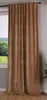A close-up view of a brown velvet curtain hanging in front of a window.