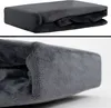 A folded dark grey plush blanket is shown in two views. Produktbild-Vorschau